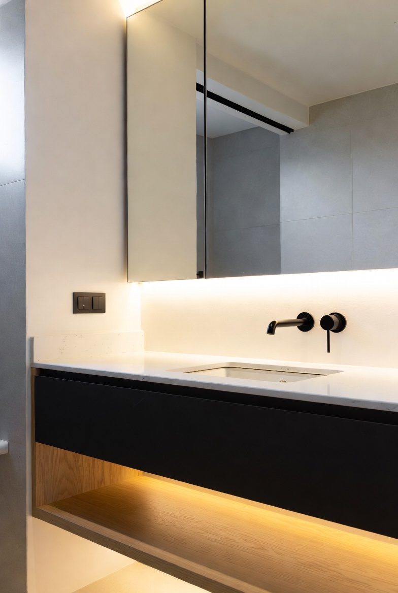 Matte black bathroom vanity with a light wood shelf accent under the mirror